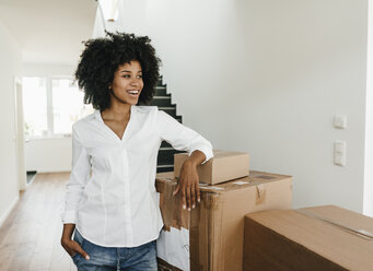 Smiling young woman with cardboard boxes - KNSF02263