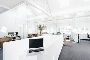 Laptop on railing in office - KNSF02319