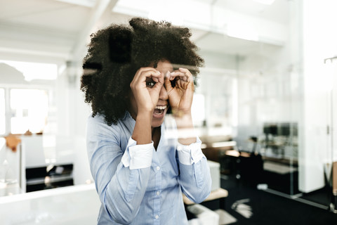 Portrait of playful young woman in office stock photo