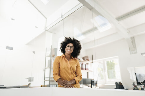 Portrait of young woman with glasses in office - KNSF02357