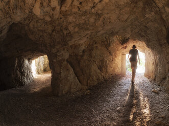 Italy, Veneto, Strada delle 52 Gallerie, hiker in a tunnel - LAF01852