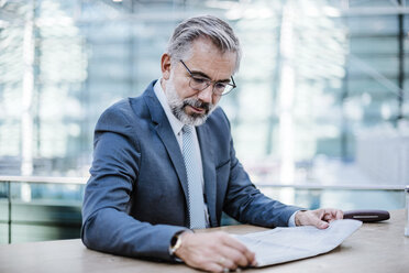 Businessman reading newspaper - DIGF02623