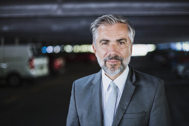 Portrait of confident businessman in parking garage - DIGF02634