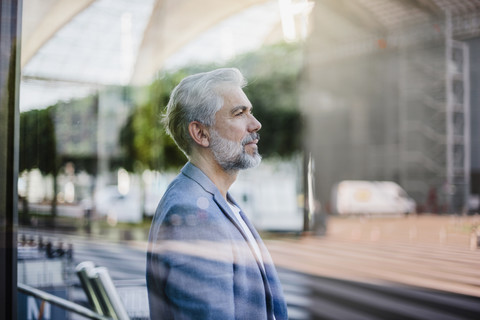 Portrait of grey-haired businessman outdoors stock photo