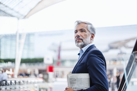 Businessman outdoors holding newspaper stock photo