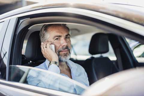 Geschäftsmann beim Telefonieren im Auto, lizenzfreies Stockfoto