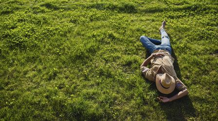 Young man sleeping on a meadow, top view - MRAF00212