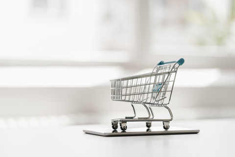 Empty mini shopping cart on tablet stock photo