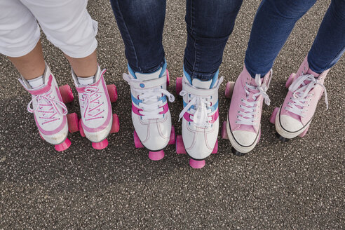 Mother and her two daughters on roller skates, partial view - NMSF00144