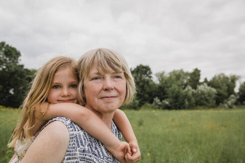 Grandmother giving granddaughter a piggyback ride - NMSF00151