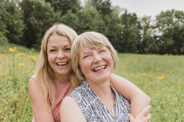 Portrait of mother and adult daughter having fun on a meadow - NMSF00153