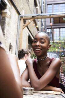 Portrait of smiling young woman in a restaurant - IGGF00116