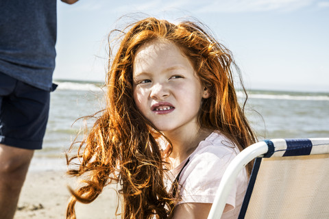 Netherlands, Zandvoort, portrait of redheaded girl on the beach stock photo