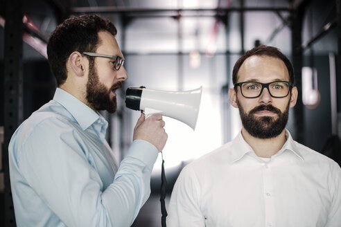 Manager mit Megaphon gibt Geschäftsleuten Anweisungen - JOSF01332