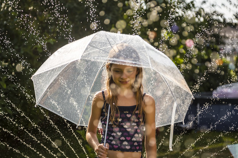 Portrait of daydreaming girl with umbrella stock photo