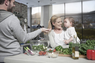 Family with baby preparing a healthy meal in kitchen - ZEF14455