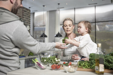 Family with baby preparing a healthy meal in kitchen - ZEF14467