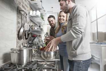 Friends preparing a meal in kitchen - ZEF14490