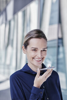 Portrait of smiling businesswoman using cell phone - RORF00988