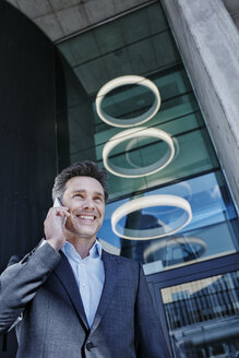 Portrait of smiling businessman on the phone - RORF01002