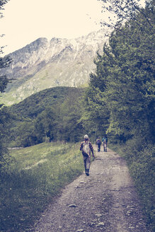 Slovenia, Bovec, three anglers walking on path towards Soca river - BMAF00306