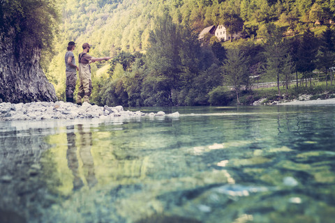 Slovenia, two men fly fishing in Soca river stock photo