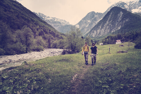 Slovenia, Bovec, two anglers walking on path towards Soca river - BMAF00324