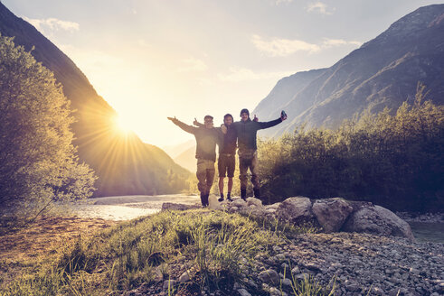 Slovenia, Bovec, three friends at Soca river at sunset - BMAF00329