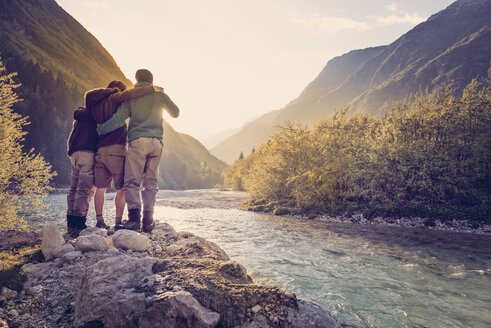 Slovenia, Bovec, three friends at Soca river at sunset - BMAF00330