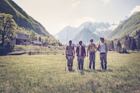 Slovenia, Bovec, four anglers standing on meadow near Soca river - BMAF00337
