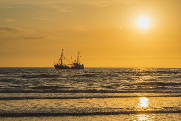 Germany, St Peter-Ording, fishing boat in sunset - KEBF00596