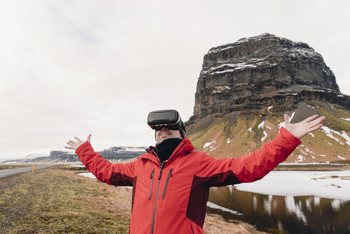 Iceland, man wearing Virtual Reality Glasses in nature - RAEF01903