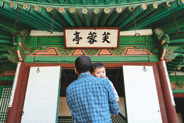 South Korea, Seoul, Father and baby girl visiting the Secret Garden in Changdeokgung Palace - GEMF01761