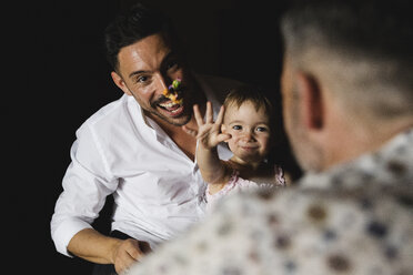 Happy gay couple playing with their little daughter at home - MRAF00239