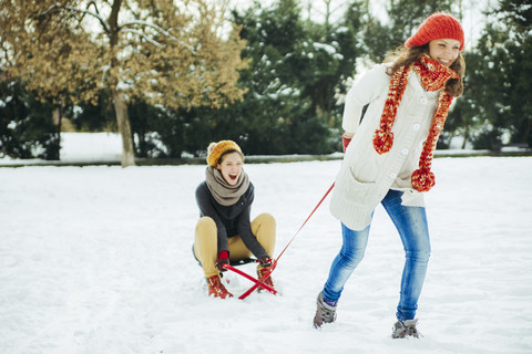 Two friends having fun in the snow stock photo