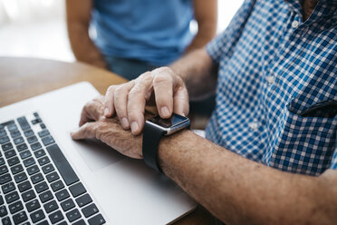 Senior man using smartwatch, close-up - JRFF01423