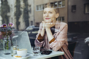 Woman with her laptop enjoying the view in a cafe - MFF03828