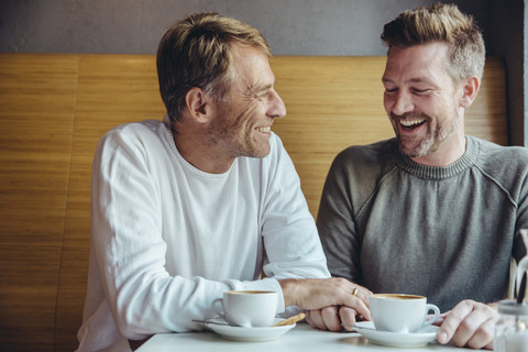 Gay couple enjoying their time together in cafe stock photo
