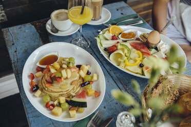 Plates with pancakes and fruit and vegetarian breakfast at cafe - MFF03917