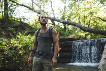 Junger Mann bei einer Wanderung an einem Wasserfall - VPIF00027