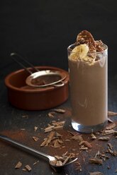 Glass of cocoa smoothie with banana, avocado, cocoa and chocolate chips - YFF00681