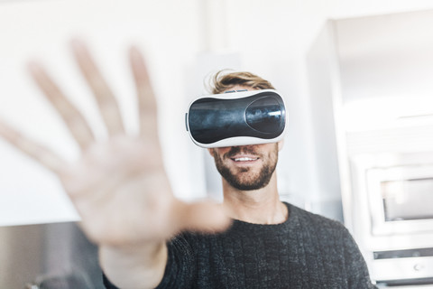 Smiling man wearing Virtual Reality Glasses stock photo