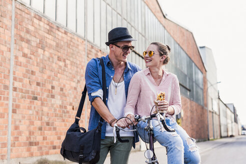 Young couple with bicycle on the street - UUF11519