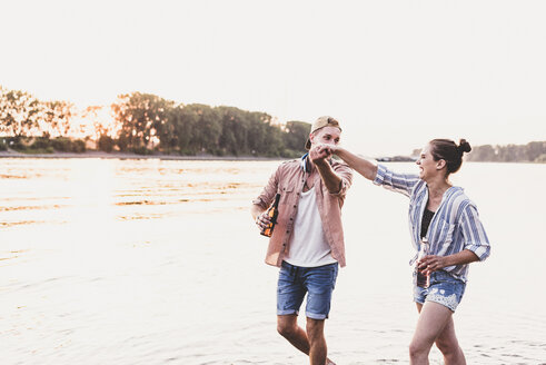 Happy young couple at a river - UUF11561