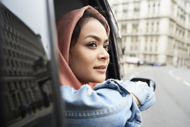 UK, England, London, young woman wearing hijab looking out of a taxi - IGGF00131