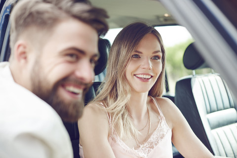 Happy young couple in car stock photo