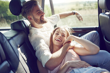 Happy young couple relaxing in car - ABIF00013