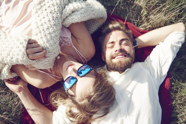 Happy young couple lying in grass - ABIF00019