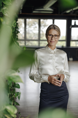 Portrait of confident businesswoman in green office stock photo