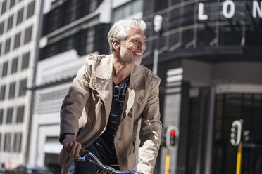 Mature man riding bicycle in the city - WESTF23492